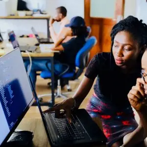 woman and man sitting in front of monitor