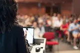 Business woman lecturing at Conference.