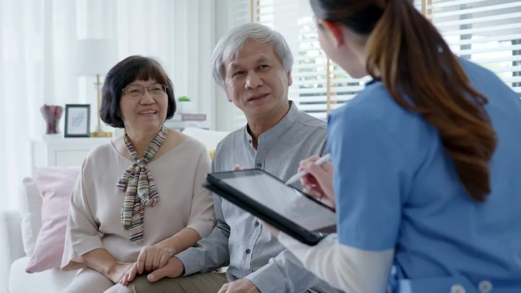 Young asia female nurse, assisted living, in-home carer or doctor visit old senior citizen at home talk about result follow up checklist, health care advice or prescription online on tablet computer.