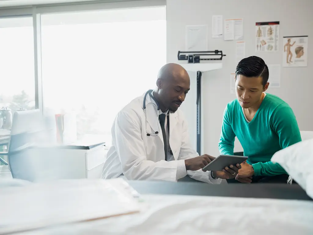 Doctor and patient looking at digital tablet